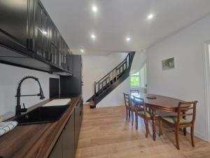 a kitchen with a wooden table and a dining room at Gite De Sandra #Confort in Olby