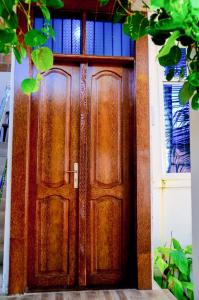 a wooden door with a window on a house at Ray Infinity Suites in Paje