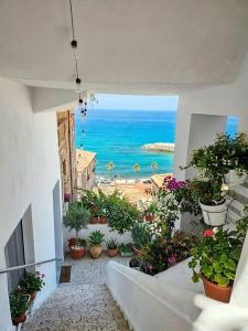 a view of the ocean from a balcony with potted plants at Casa Janca Pizzo in Pizzo