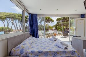 a bedroom with a bed and a large window at Casamicciola Rooms in Casamicciola Terme