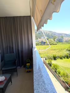 a view from the balcony of a house with a table and a chair at The Flip-Flop Apartment in Shëngjin