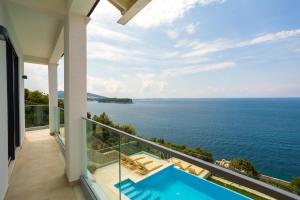 a view of the ocean from the balcony of a house at Villa VI in Dubrovnik