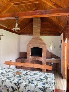 a bedroom with a fireplace and a bed in a room at Popas Turistic Gyl in Arieşeni