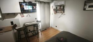 a living room with a table and a bar in a room at Le Ventoux - Studio Climatisé - Provence in Aubignan