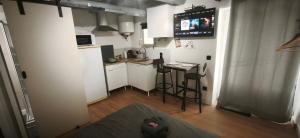 a small kitchen with a small table in a room at Le Ventoux - Studio Climatisé - Provence in Aubignan +8 photos