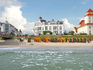 a group of buildings on a beach near the water at Strandschloss Binz - Penthouse "Royal Beach" mit Sauna, Kamin, Terrasse, Meerblick in Binz +34 photos