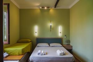 two beds in a room with green walls at Casale Incanto in Terracina +53 photos