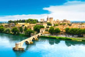 a bridge over a river in front of a city at Le Ventoux - Studio Climatisé - Provence in Aubignan