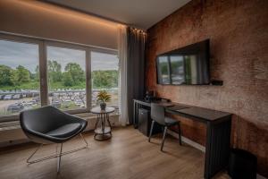 a room with a desk and a television on a wall at Industrial Design Studios - Lohnhalle Essen in Essen