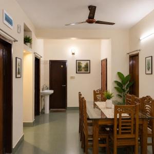a dining room with a table and chairs and a ceiling fan at Jannat Residential Hotel in Atgaon