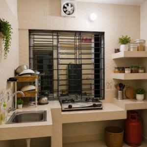 a kitchen with a sink and a window at Jannat Residential Hotel in Atgaon +14 photos