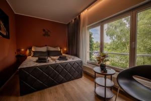 a bedroom with a large bed and large windows at Industrial Design Studios - Lohnhalle Essen in Essen