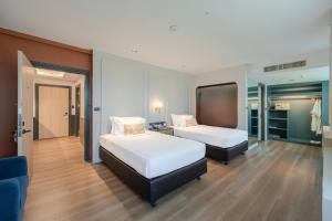 a hotel room with two beds and a tv at A-ONE Bangkok Hotel in Bangkok +57 photos