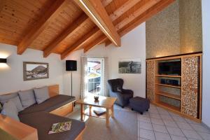 a living room with a couch and a table at Haus im Wäldle in Balderschwang