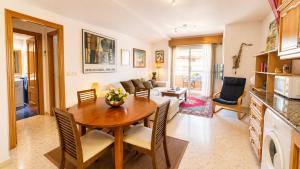 a kitchen and living room with a table and chairs at Tirolina by Edeal HOMES in Denia