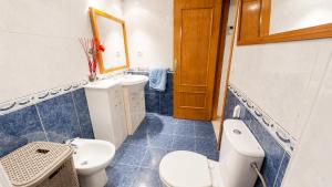 a bathroom with a toilet and a sink and a mirror at Tirolina by Edeal HOMES in Denia