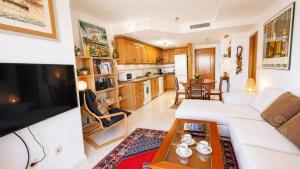 a living room with a white couch and a table at Tirolina by Edeal HOMES in Denia +11 photos