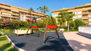 a playground in front of a apartment building at Tirolina by Edeal HOMES in Denia