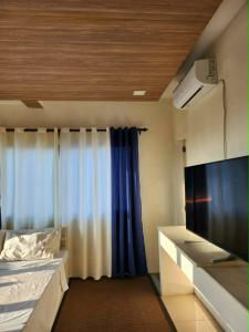 a small room with a bed and a window at R Hotel Centro and Restaurant in Marinduque
