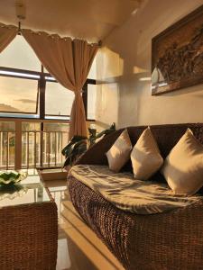 a living room with a couch and a window at R Hotel Centro and Restaurant in Marinduque +18 photos