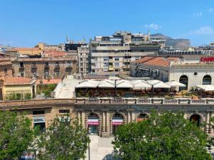 a view of a building with umbrellas in a city at Cavour 106 Apartment in Palermo