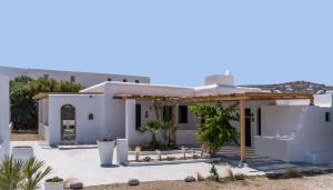 a white house with a pergola at Ornos Collection - by Hospirit in Ornos