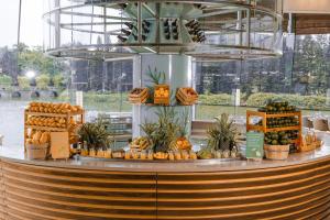 a food counter with fruits and vegetables on it at JW Marriott Hotel Hanoi in Hanoi