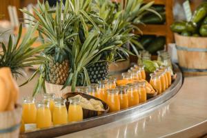 a tray of orange juice and pineapples on a table at JW Marriott Hotel Hanoi in Hanoi