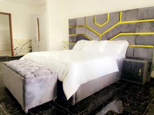 a bedroom with a large bed and a painting on the wall at Golden fortune Hotel apartment in Molyko +2 photos