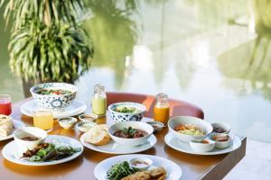 a table topped with plates of food and drinks at JW Marriott Hotel Hanoi in Hanoi
