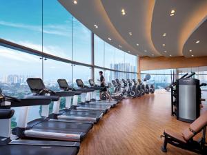 a gym at the top of a building with treadmills at JW Marriott Hotel Hanoi in Hanoi