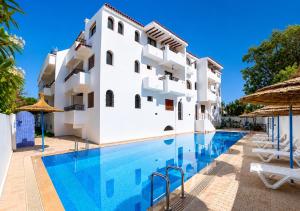 a swimming pool in front of a building at Andalucia Cabo in Cabo Negro