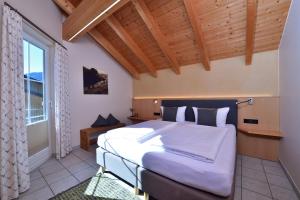 a bedroom with a large bed and a window at Haus im Wäldle in Balderschwang