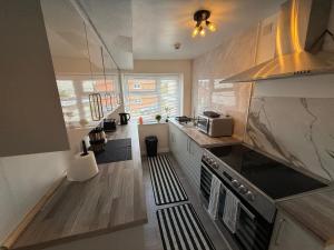 a kitchen with a sink and a stove top oven at Grande Italia Rooms Comfort Italian Hospitality 4 in Ebley