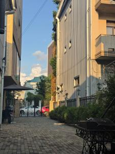a cobblestone street in a city with buildings at Kobuleti apartment in Kobuleti