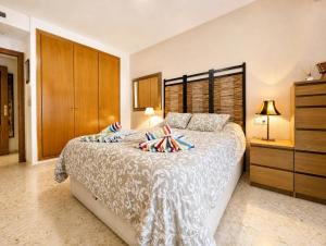 a bedroom with a large bed with pillows on it at Tirolina by Edeal HOMES in Denia
