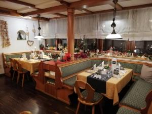 a restaurant with two tables and chairs and a bar at Hotel-Gasthof Lamm in Rot am See