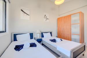 a bedroom with two beds and a closet at Merika Complex 1 in Perivolia