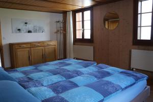 a bedroom with a blue comforter on a bed at Naturfreunde in Hergiswil