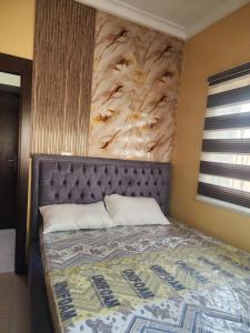 a bedroom with a bed with a flower wall at The Oasis in Ilorin