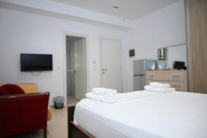a hotel room with a bed and a television at Golden Berden Boutique Apart-Hotel in Sarandë