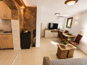 a kitchen and a living room with a table at Peace in Bečići