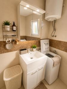 a small bathroom with a sink and a mirror at Peace in Bečići