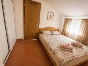 a bedroom with a bed with two pink pillows on it at Peace in Bečići