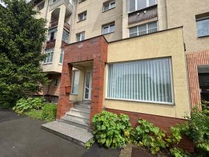 a brick house with a window and some plants at Cazare Târgu Secuiesc in Târgu Secuiesc