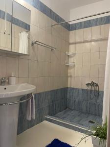 a bathroom with a shower and a sink at Sea And Sand Apartment in Nea Kallikrateia +19 photos