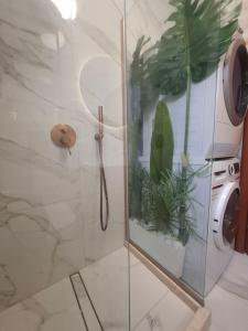 a shower with a glass door with plants in it at SuiteViewPoros-Luxury Apartment in Galatas in Galatas +45 photos