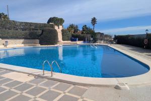a large blue swimming pool in a yard at Casa Morendo in Teulada