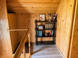 a room with wooden walls and a book shelf at Takovo Hills in Vrnčani