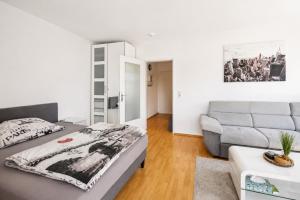 a bedroom with a bed and a couch at Charmante Stadtwohnung im Zentrum in Wiesbaden